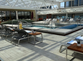 The pool area, with the moveable roof covering to protect from the elements.